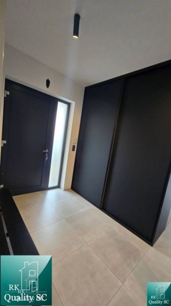 Entrance hallway in a family house with dark doors and a large wardrobe.