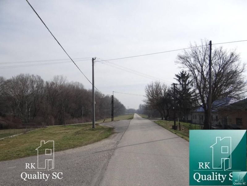 A beautiful road in the Old Port of Gabčíkovo for living, surrounded by trees on the plots.