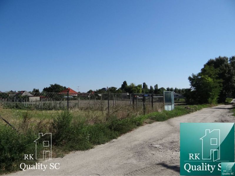 Plots - housing on Vrbová Street in Jelka, enclosed by a wire mesh fence.