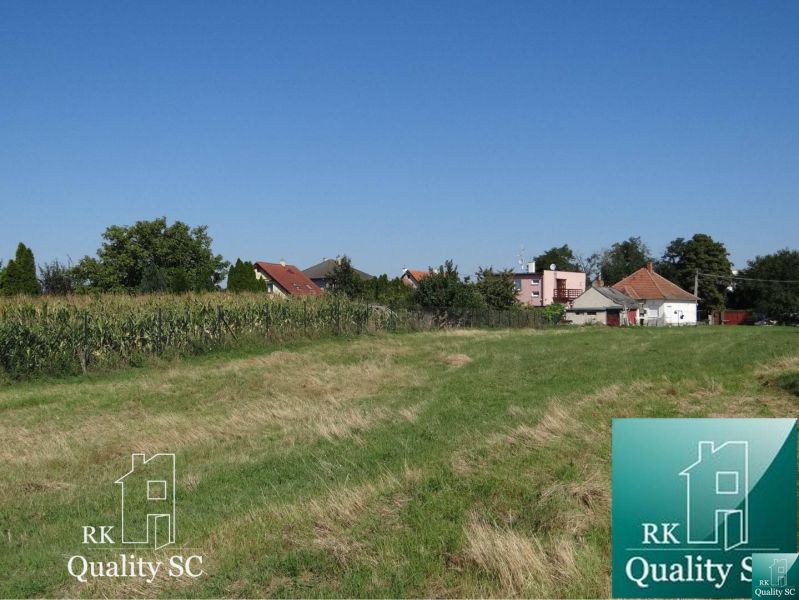 Plots - housing on Jelka - Vrbová street near Galanta. Grass area and houses in the background.