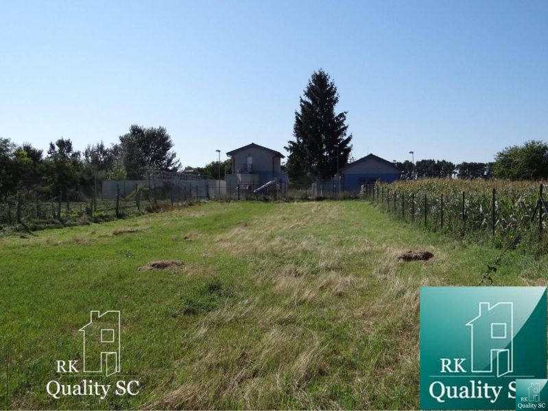 Residential plots in Galanta on Jelka - Vrbová Street, with a grassy area and a tree.