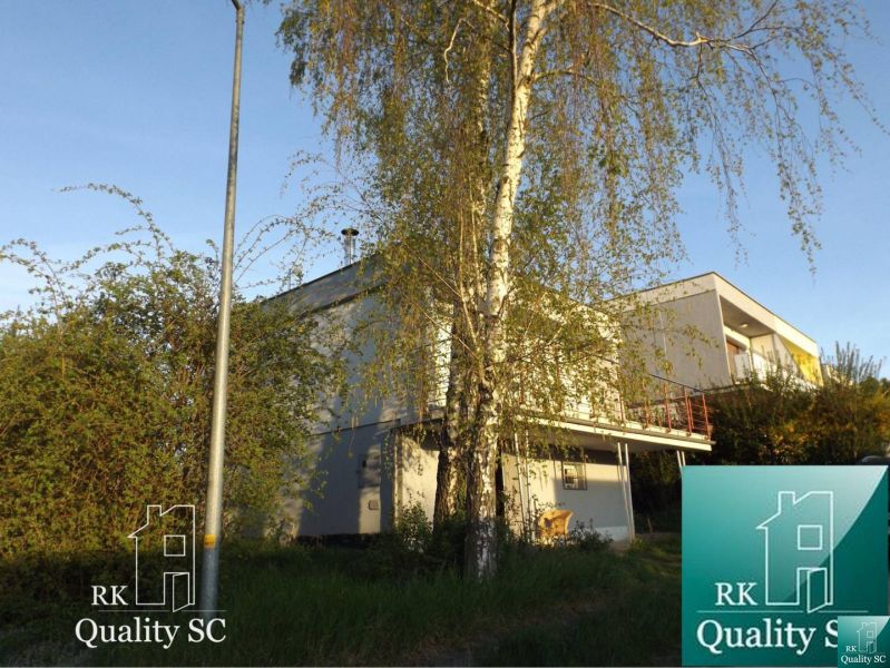 A cottage in Senec at SUNNY LAKES SOUTH with a garden and greenery.