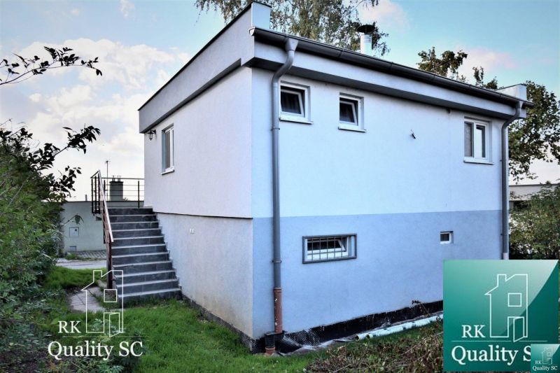 Cottage at SUNNY LAKES SOUTH in Senec with a staircase and a light facade.
