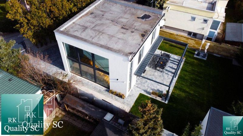 A family house at Sunny Lakes South in Senec with large windows and a terrace.