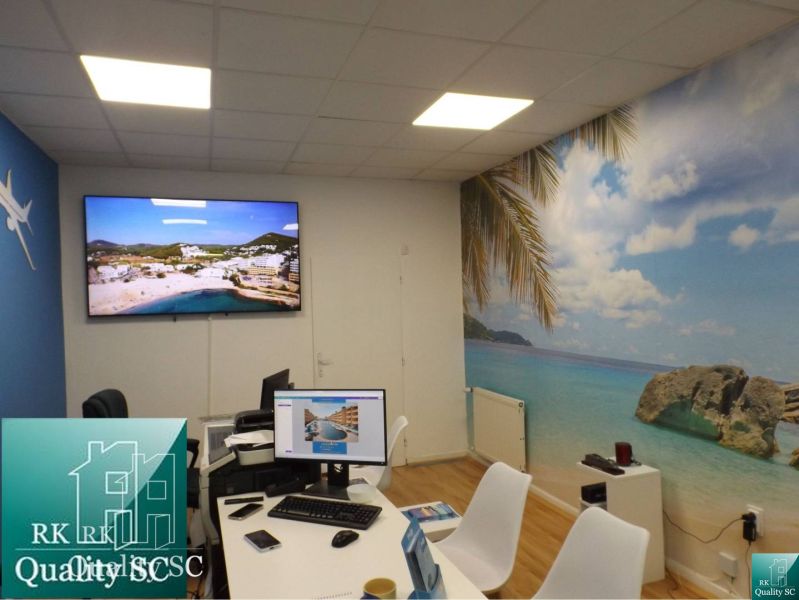 Interior of a family house with beach decor, table, and computers.