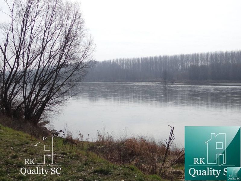 River with a misty background and bank near the Old Gabčíkovo Harbor. Land - residential.