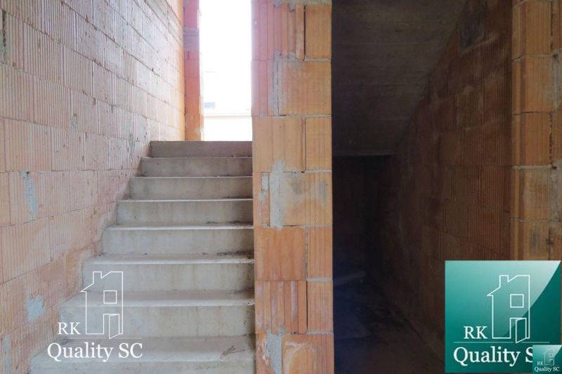 Staircase and brick walls inside a family house under construction.
