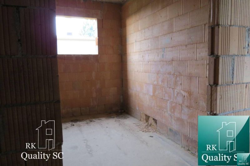 Interior of a family house with a rough construction and brick walls.