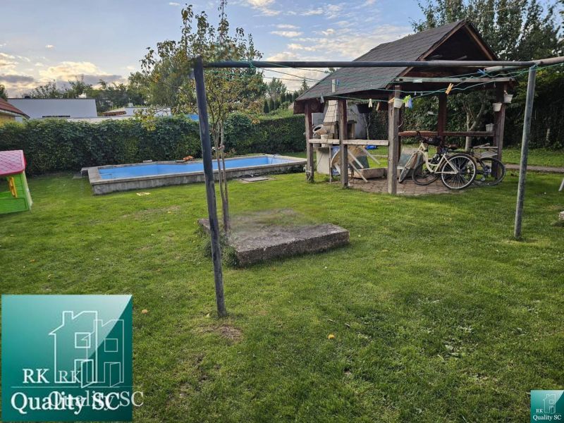 The garden of a family house in Tureň, Tureň with a gazebo, swimming pool, and lawn.