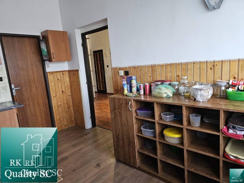 A kitchen with a wooden floor decor in a family house.