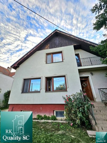 A family house in the town of Tureň on Tureň Street with a front garden and a staircase.
