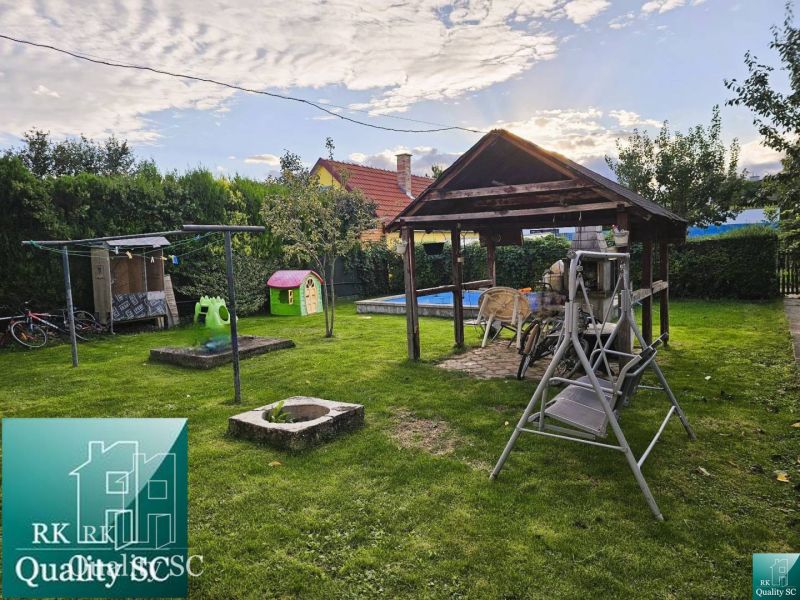 The garden of a family house in Tureň with a gazebo, swing, and children's playground on Tureň street.