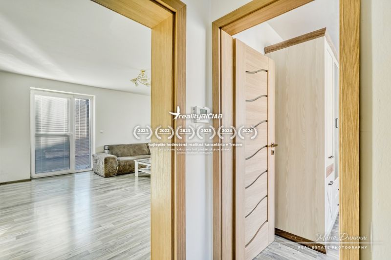 Interior of a family house with a wooden decor floor and a comfortable sofa set.
