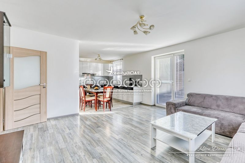 Interior of a family house with an open kitchen and living room, floor with wooden decor.