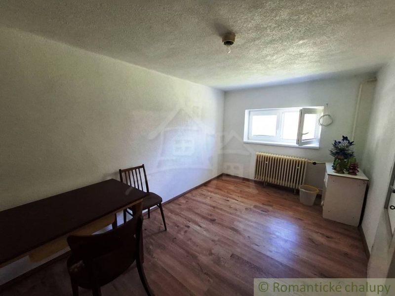 The interior of a family house with simple furniture and a wooden decor floor.