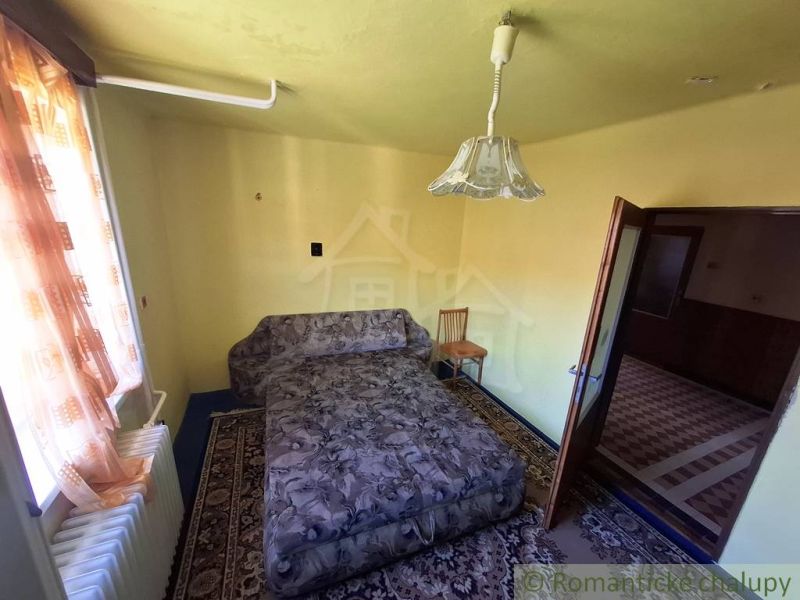 A room with a sofa, chair, carpet, and curtains. A stylish interior of a family house.