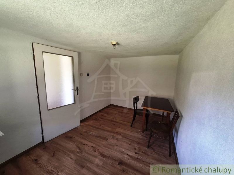 A simple room in a family house with wooden decor flooring.