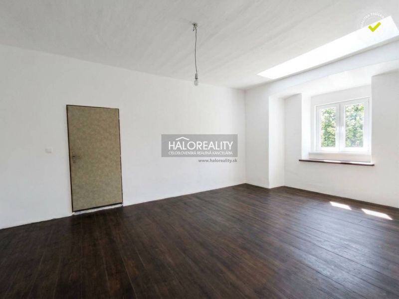 A space with white walls and a wooden decor floor in a 3-room apartment.