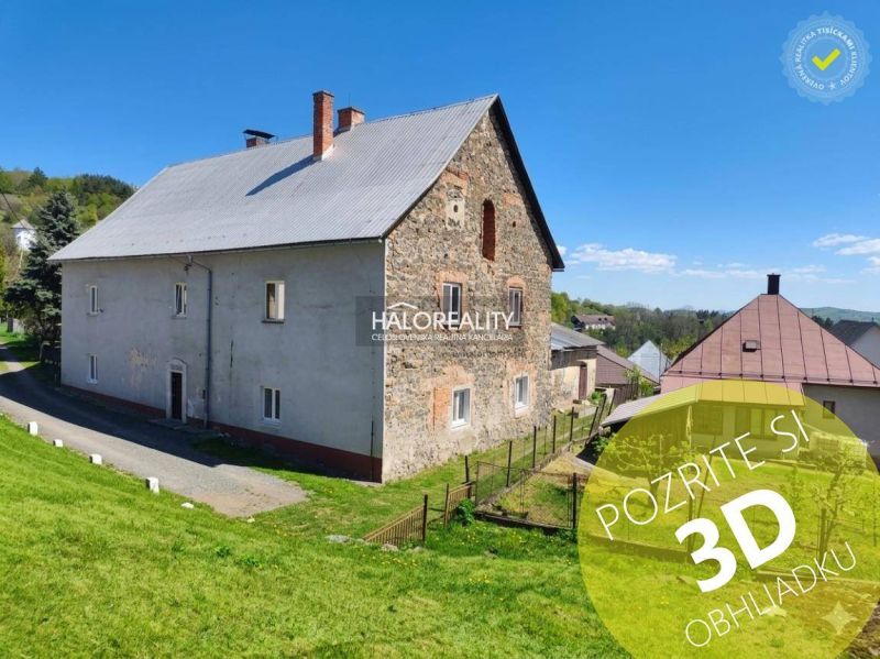 Stone house with a gray roof and a garden in Štiavnické Bane.