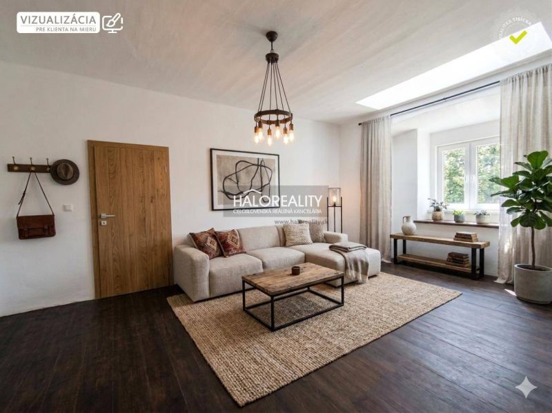 Living room of a three-room apartment with a wooden decor floor and a large window.