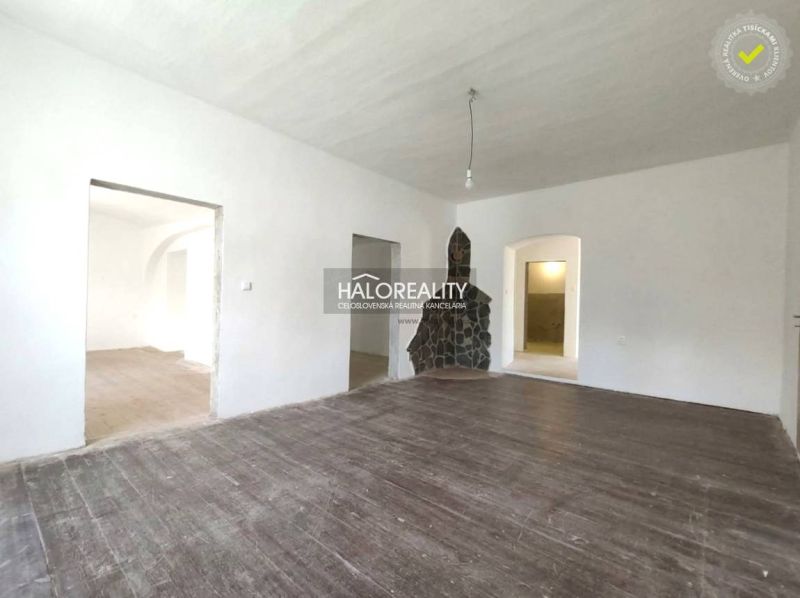 A room in a 3-room apartment with a wooden decor floor and smooth white walls.