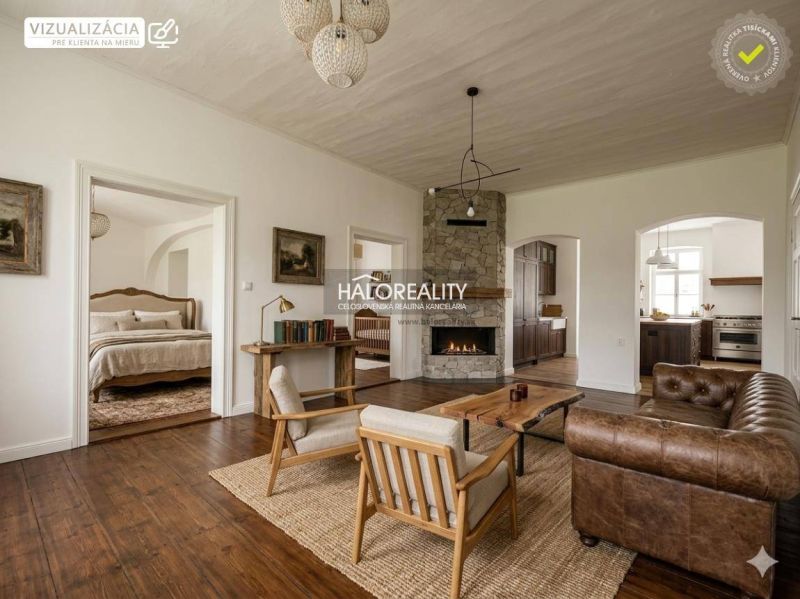 Living room in a 3-room apartment with a fireplace, wooden decor flooring, and a leather sofa.