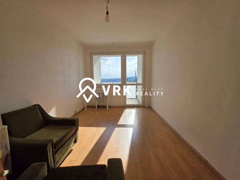 Living room in a 4-room apartment with a wooden decor floor and sofas.