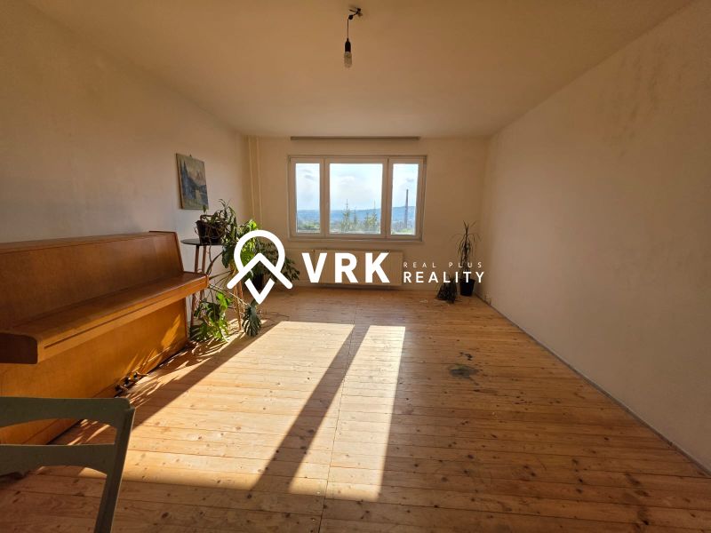 A bright room with a piano and a wooden decor floor in a 4-room apartment.