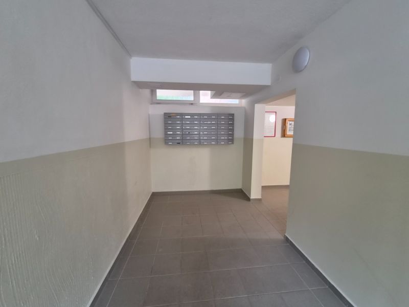 A hallway with mailboxes in a 2-room apartment.