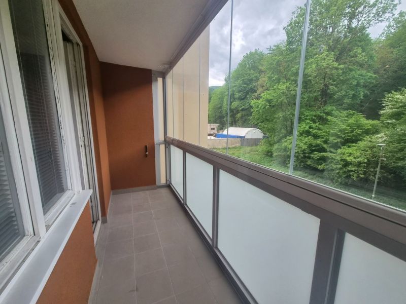 A glazed balcony of a 2-room apartment with a view of the forest in Trenčianske Teplice, Štvrt SNP.