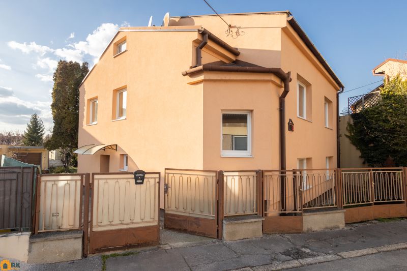 A family house on Mlynska Street in Piešťany with an orange facade and a fence.
