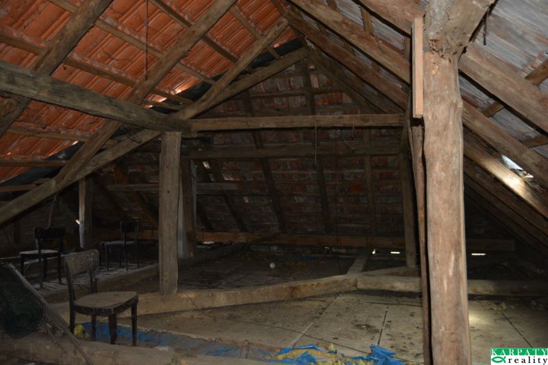 The attic of a family house with wooden beams, ideal for renovation and storage space.