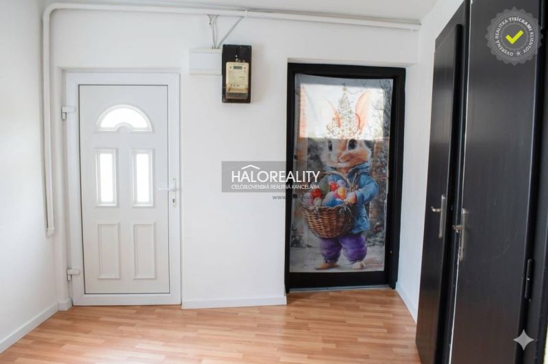 The interior of a family house with white doors and a floor with a wood decor.