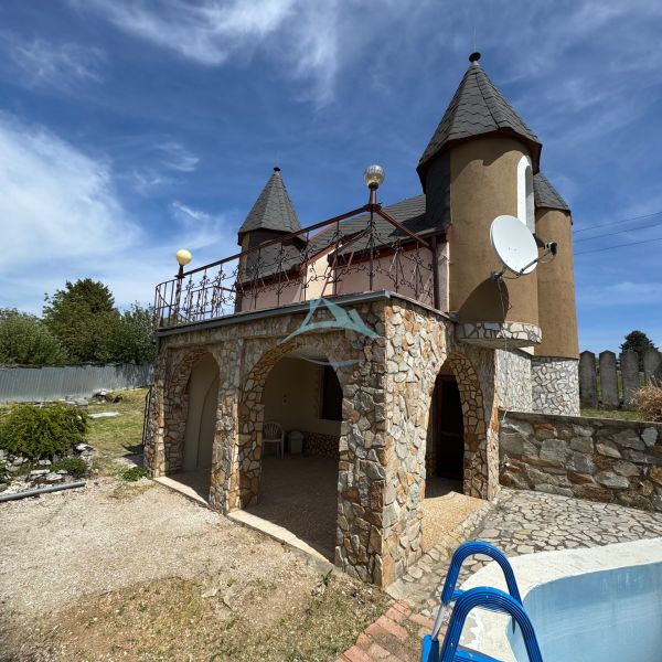 A house on Agátová Street in Šahy with a stone facade and a small pool in the front.