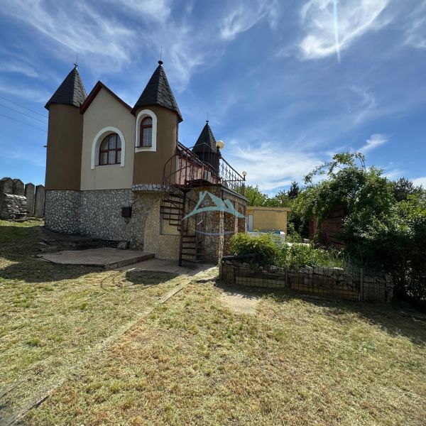 The house on Agátová Street in Šahy with turrets and a lawn.