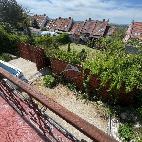 The view from the terrace of the cottage on Agátová Street in Šahy with swaying bushes.