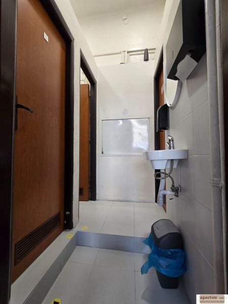 Sink, soap dispenser, and doors in the interior of gastro premises.