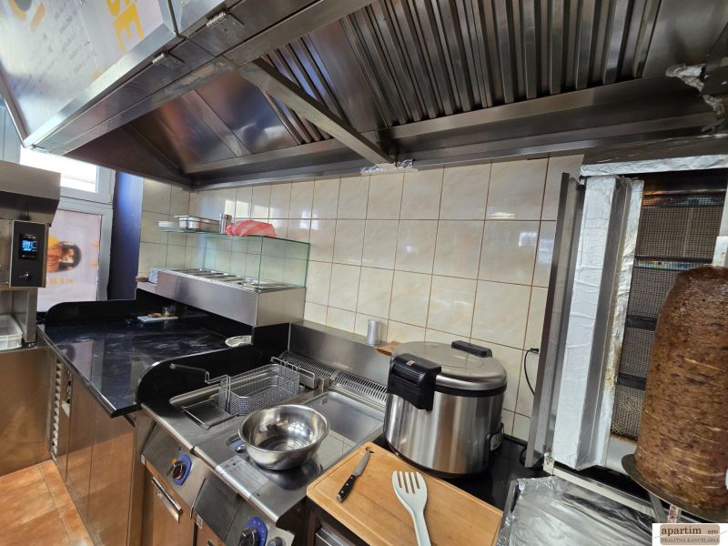 Kitchen equipment in gastro spaces with a grill and fryer for meal preparation.