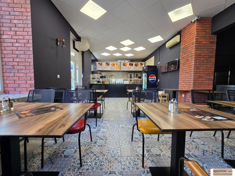Gastro premises with a wooden decor floor and brick wall cladding.