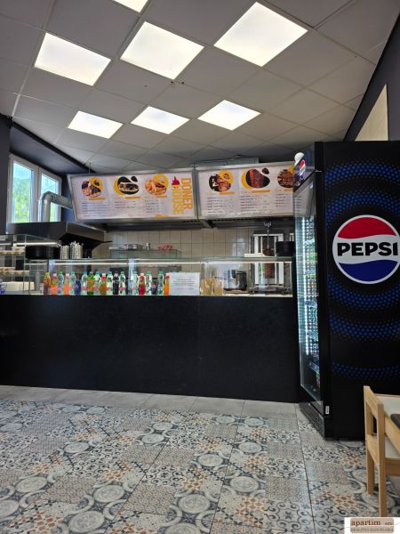 Gastro premises with a beverage offer, a Pepsi fridge, and tiles with ornaments.