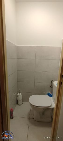 Bathroom with toilet and tiles in a 2-room apartment.
