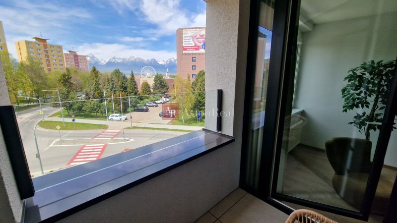 View from a 2-room apartment on Karpatská Street in Poprad with snow-covered mountains in the background.