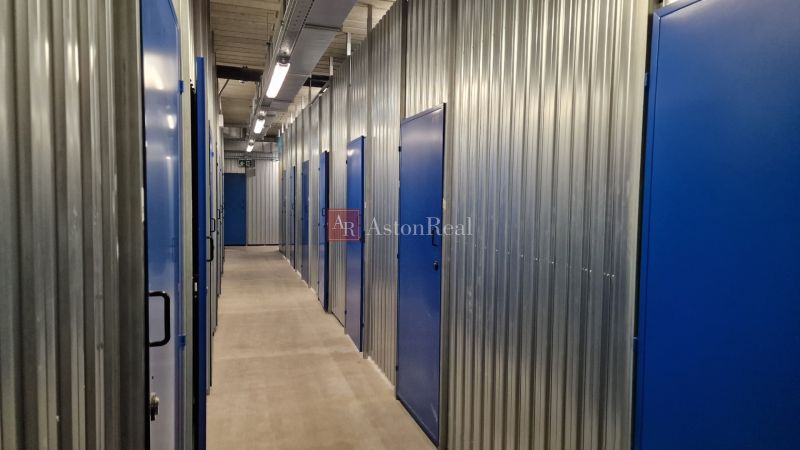 Storage spaces with blue doors and steel walls in a 2-room apartment.