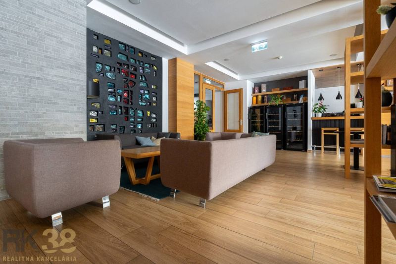 Living room in a holiday apartment with a decorative wall and a wooden decor floor.