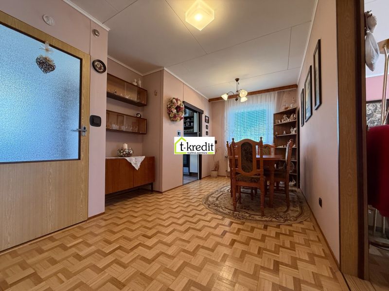 Dining room in a family house with a wooden decor floor and classic furnishings.