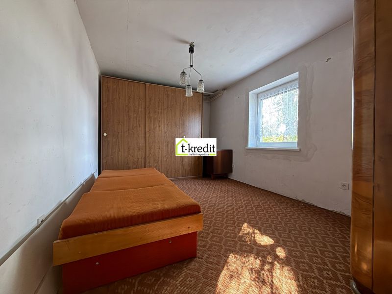 Bedroom with a bed and built-in wardrobe in a family house.