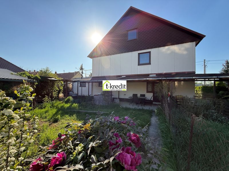 A family house in Zlaté Moravce with a blooming garden and a lush lawn.
