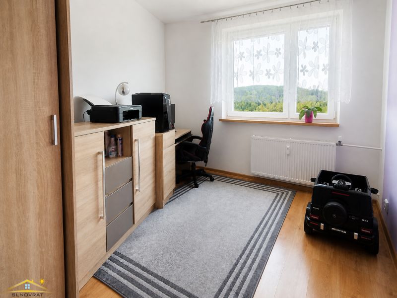 A workspace with a chest of drawers and a view from the window in a 3-room apartment.