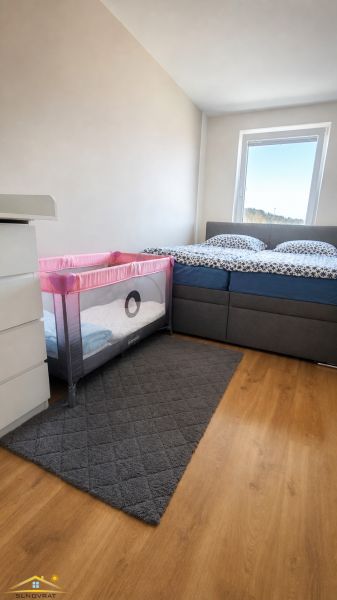 Bedroom with a baby crib in a 3-room apartment, floor with wooden decor.