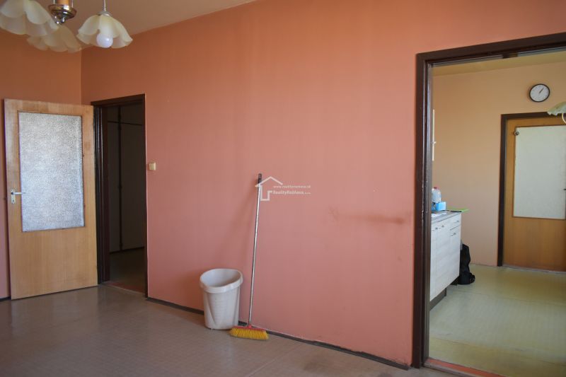 Interior of a 3-room apartment with colorful walls and a kitchen unit.